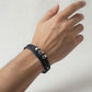 Black braided leather bracelet with metallic clasp